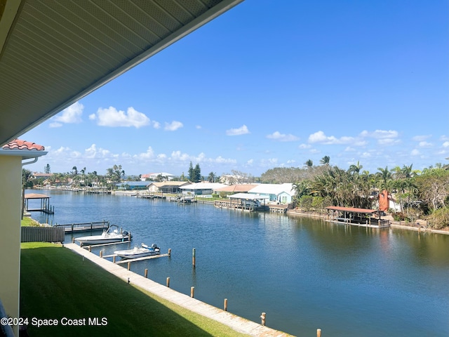 view of dock with boat lift and a water view