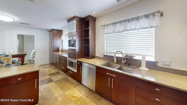 kitchen featuring wall oven, sink, and stainless steel dishwasher