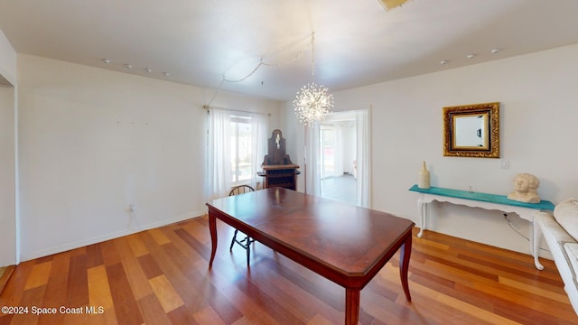 interior space featuring hardwood / wood-style floors and an inviting chandelier