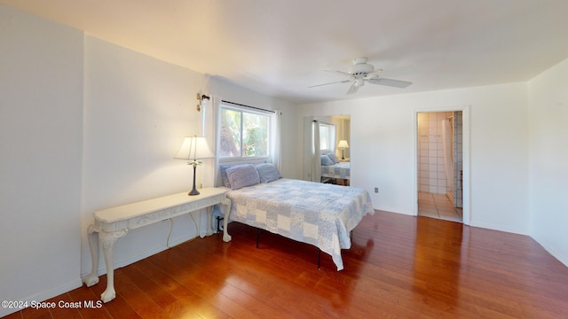 bedroom featuring ceiling fan, hardwood / wood-style floors, and ensuite bathroom