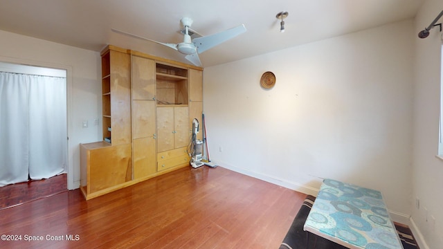 bedroom with ceiling fan and dark wood-type flooring