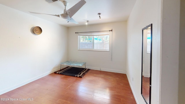 spare room featuring hardwood / wood-style floors and ceiling fan