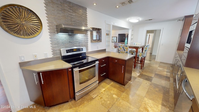 kitchen with kitchen peninsula, backsplash, stainless steel range with electric stovetop, and wall chimney range hood