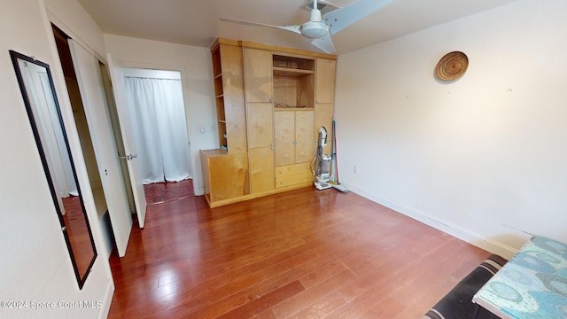 unfurnished bedroom with a closet, ceiling fan, and dark wood-type flooring