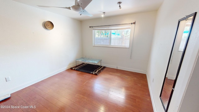 spare room featuring hardwood / wood-style floors and ceiling fan