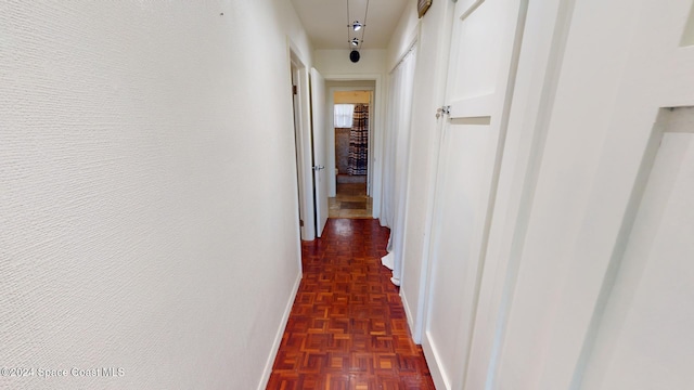 hallway featuring dark parquet flooring