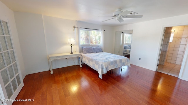 bedroom featuring ensuite bathroom, ceiling fan, and wood-type flooring