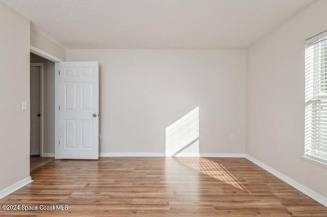 unfurnished room with light hardwood / wood-style flooring