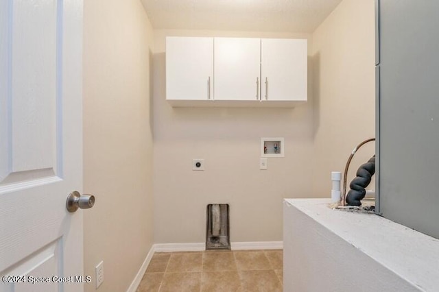 washroom with hookup for a washing machine, light tile patterned flooring, cabinets, and electric dryer hookup