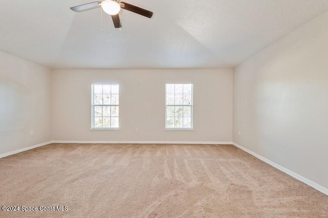 empty room with light colored carpet and ceiling fan