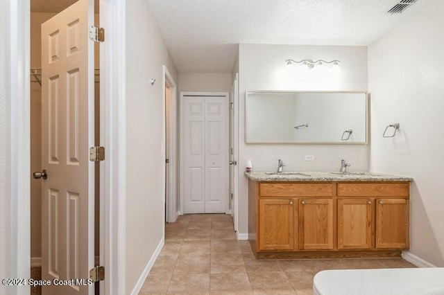 bathroom featuring vanity, toilet, and tile patterned floors