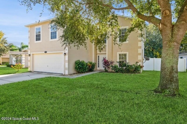 view of front of property with a front yard and a garage