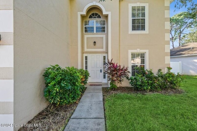 entrance to property with a yard