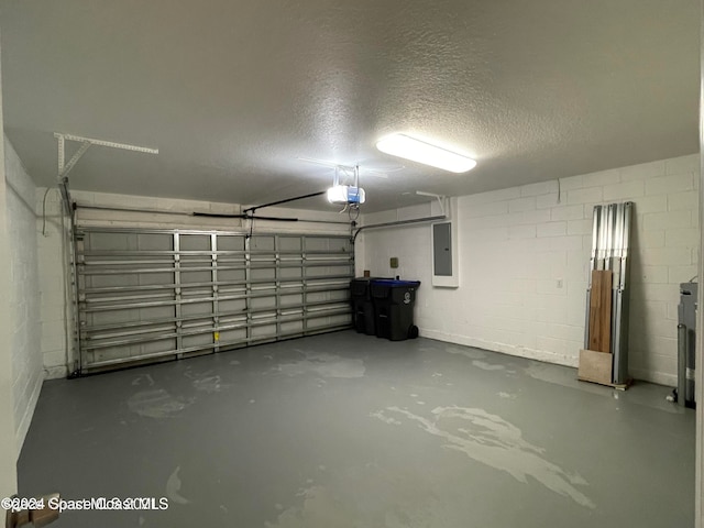 garage with a garage door opener and electric panel