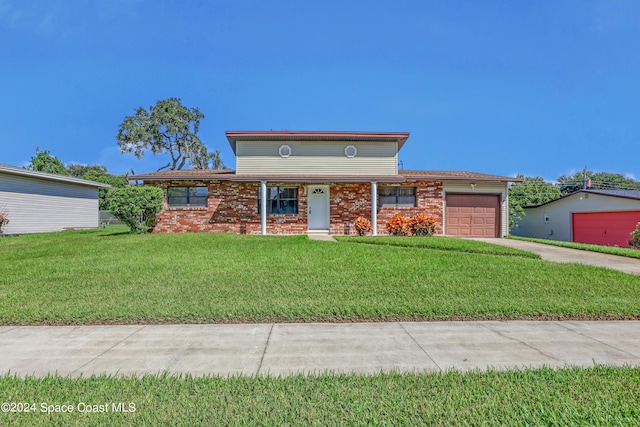 view of front of home featuring a garage and a front lawn