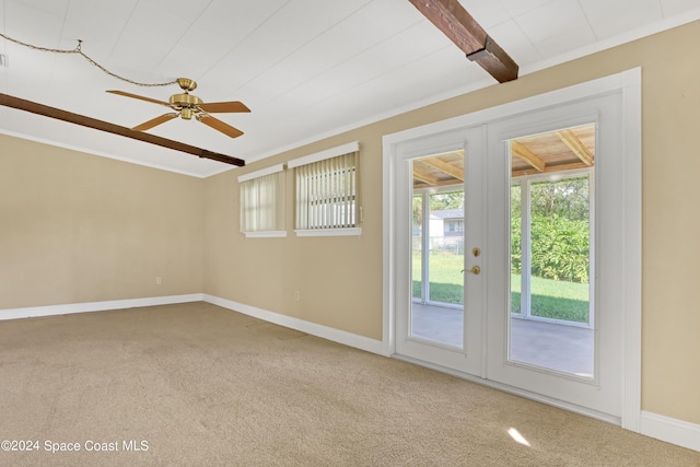 carpeted empty room with beamed ceiling, french doors, crown molding, and ceiling fan