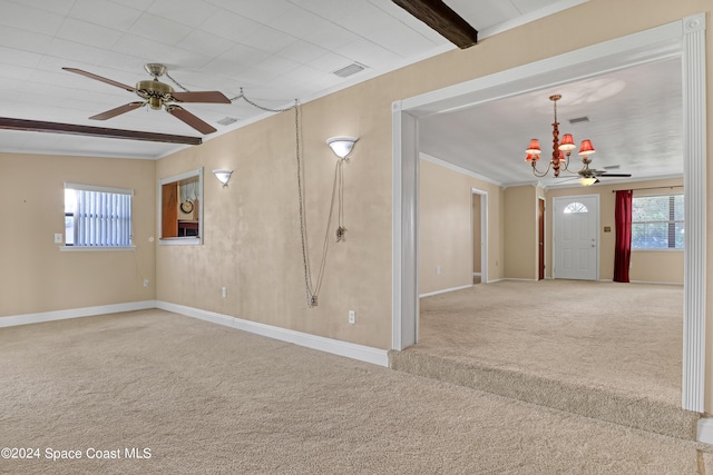 carpeted empty room with crown molding, vaulted ceiling with beams, and ceiling fan with notable chandelier