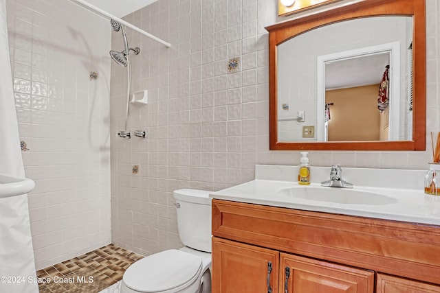 bathroom featuring vanity, toilet, tile walls, and a shower with curtain