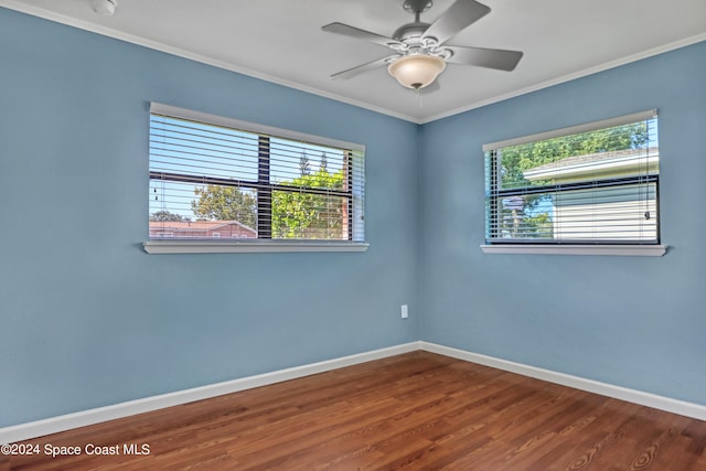 unfurnished room featuring ornamental molding, a healthy amount of sunlight, wood-type flooring, and ceiling fan