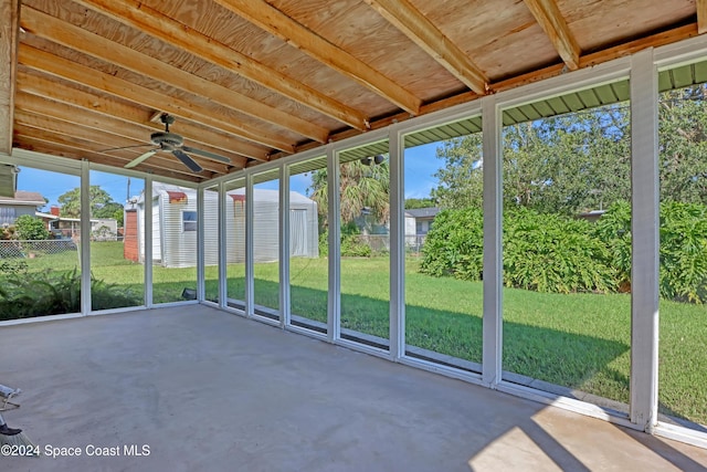 unfurnished sunroom with a wealth of natural light and ceiling fan