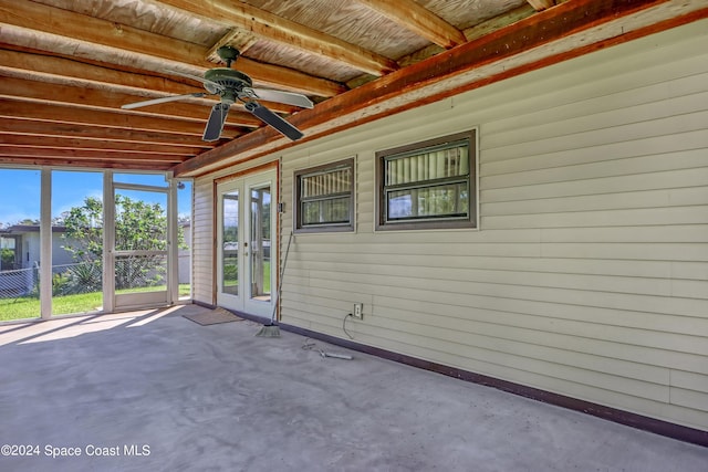 unfurnished sunroom with ceiling fan