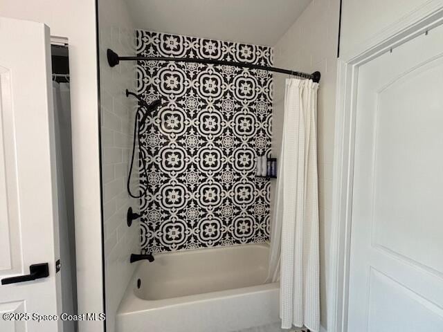 bathroom with shower / bathtub combination with curtain