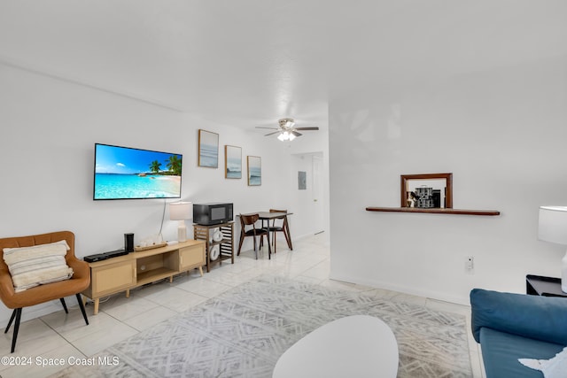 tiled living room with ceiling fan