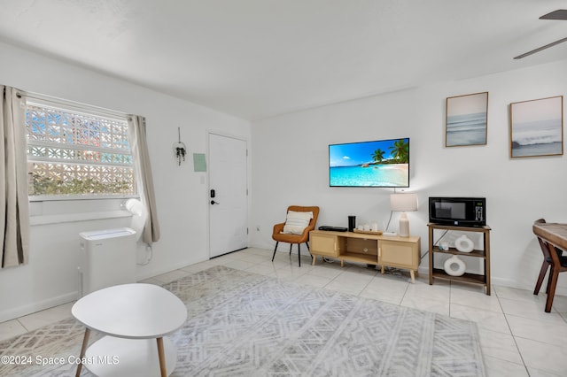 living room featuring light tile patterned flooring and ceiling fan