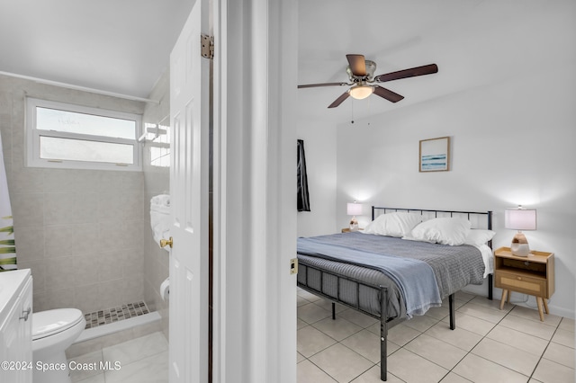 tiled bedroom featuring ceiling fan