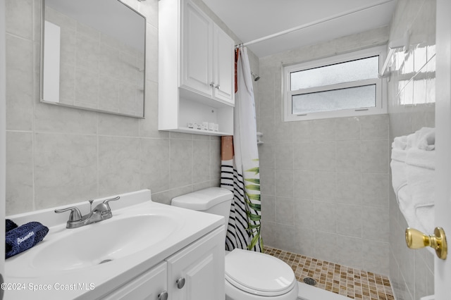 bathroom with toilet, backsplash, vanity, curtained shower, and tile walls