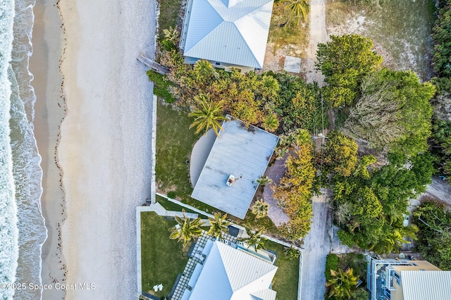 birds eye view of property with a view of the beach and a water view