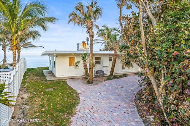 view of front of house with a water view