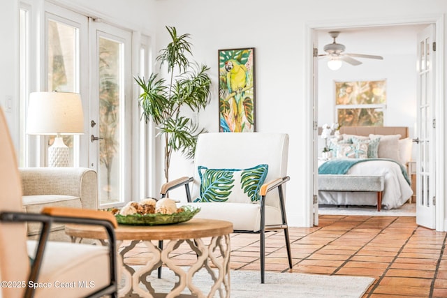 living area featuring plenty of natural light and ceiling fan