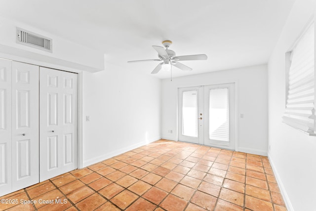 interior space with french doors and ceiling fan