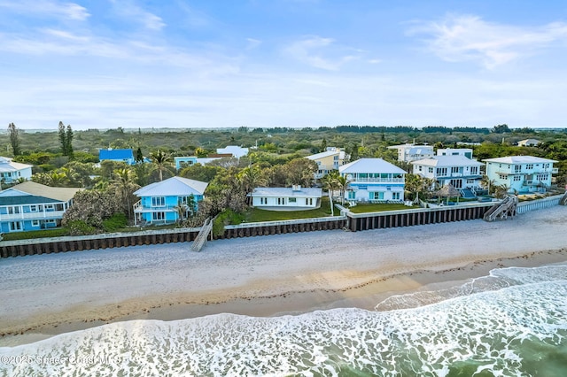 bird's eye view featuring a view of the beach and a water view