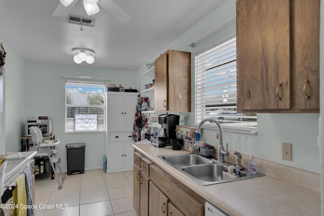 kitchen with light tile patterned floors, sink, and ceiling fan