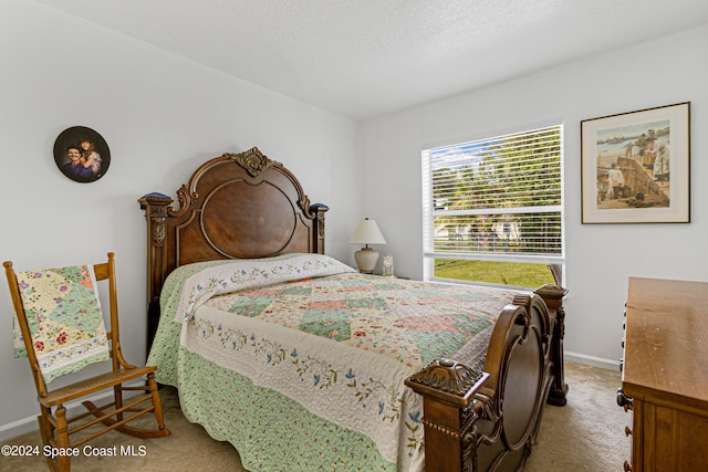 carpeted bedroom featuring a textured ceiling