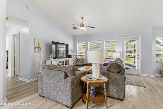 living room featuring ceiling fan, light hardwood / wood-style flooring, and lofted ceiling