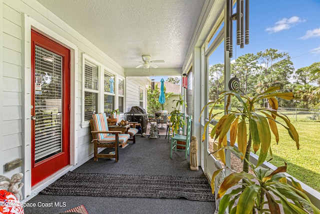 sunroom featuring ceiling fan and a healthy amount of sunlight