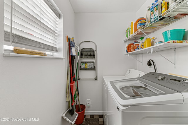 clothes washing area featuring washer and dryer