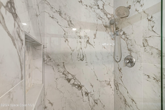 interior details featuring tiled shower