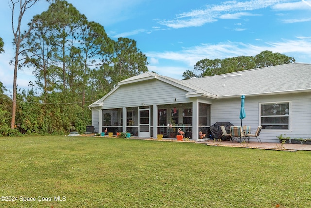 back of house with a lawn, a patio area, and a sunroom