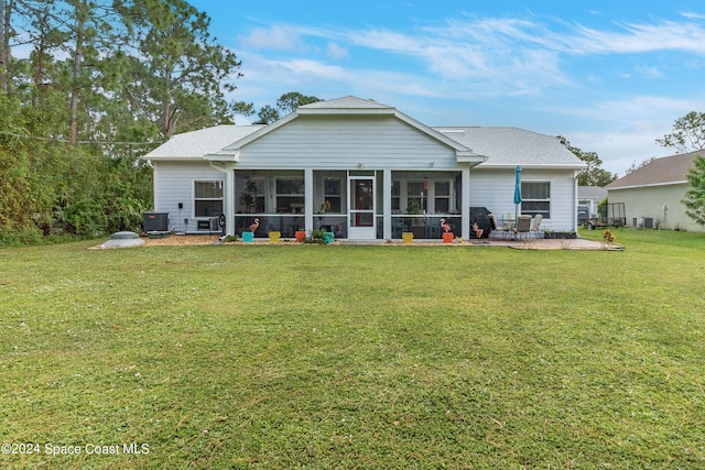 back of house with a yard, central air condition unit, a patio area, and a sunroom