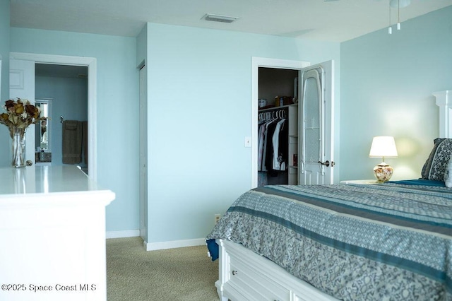 bedroom with a closet and light carpet