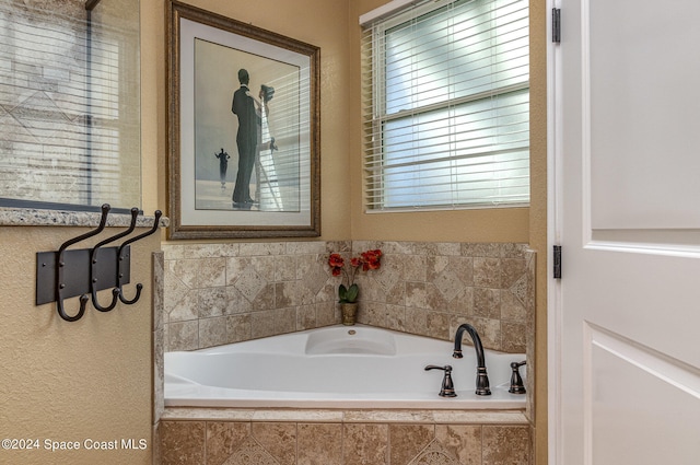 bathroom featuring tiled tub