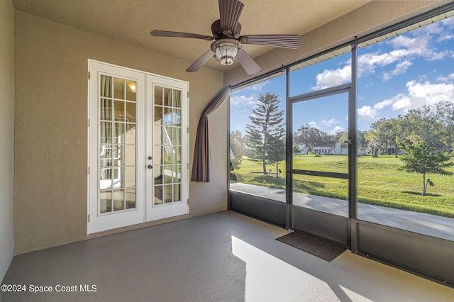 unfurnished sunroom featuring french doors and ceiling fan