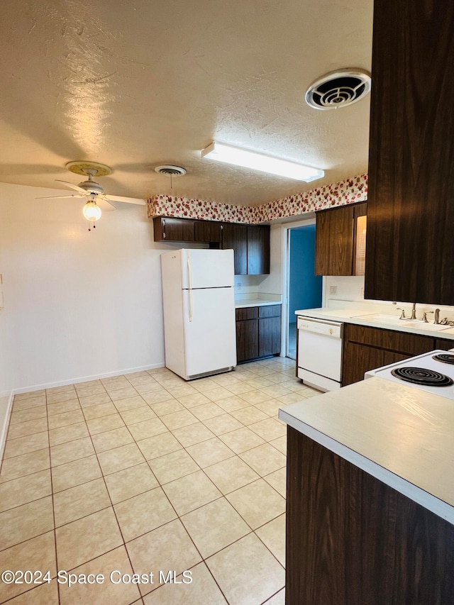 kitchen with dark brown cabinetry, ceiling fan, a textured ceiling, white appliances, and light tile patterned flooring