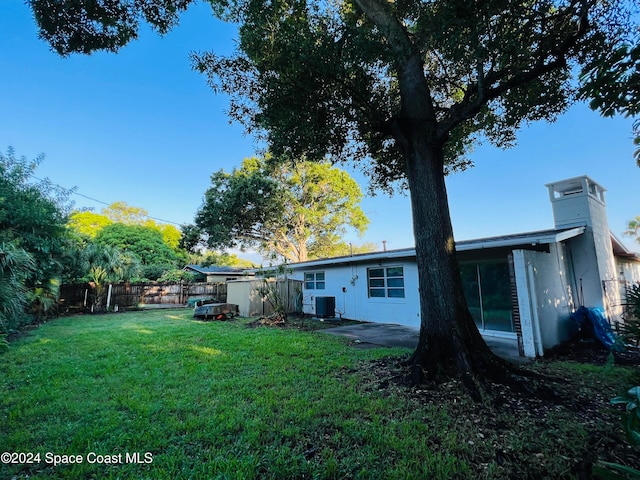 view of yard featuring central AC unit and a patio area