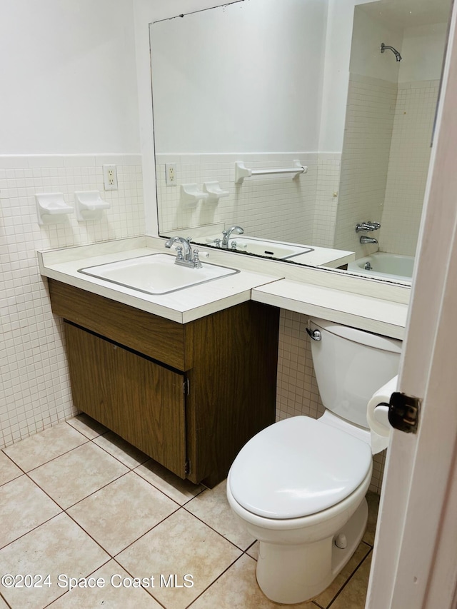 full bathroom featuring tile patterned floors, vanity, toilet, and tile walls