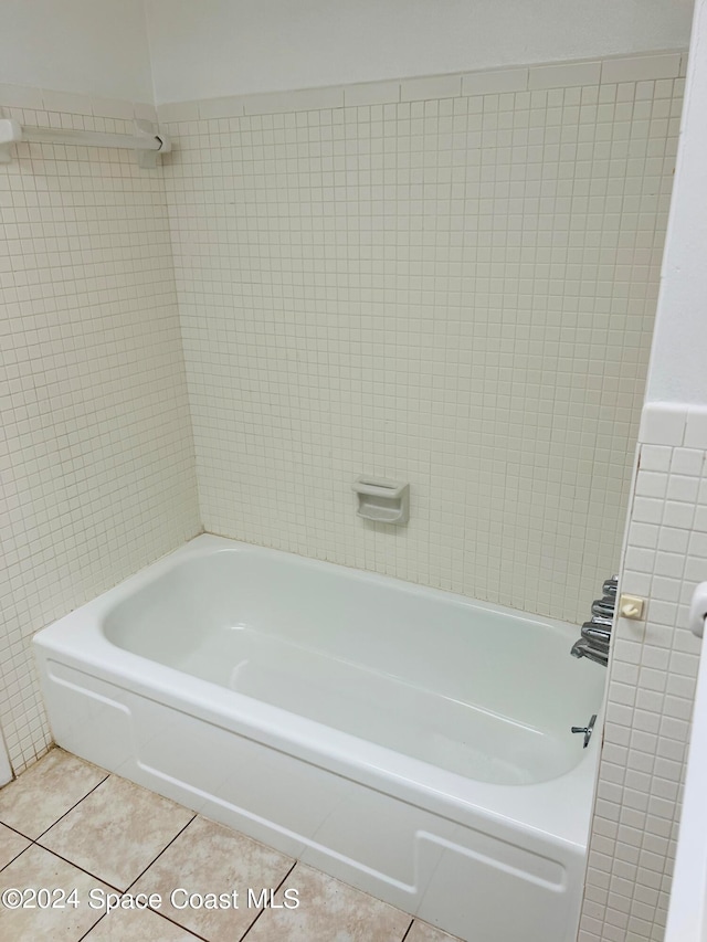 bathroom with tile patterned floors and tile walls